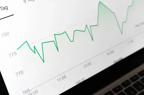 Laptop screen displaying a line graph showing performance metrics over time, representing performance optimization.